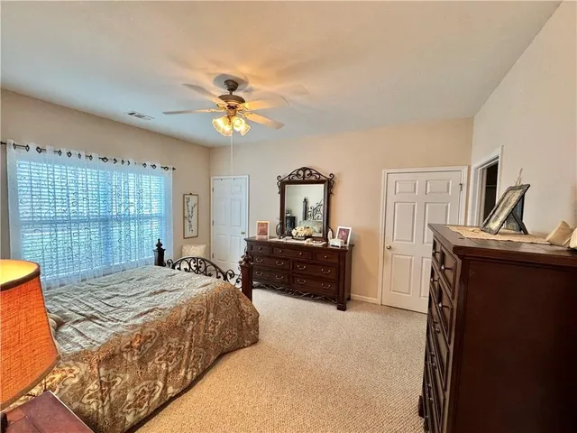 a bedroom with a table and a chair