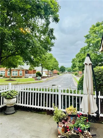 a view of a house with wooden deck and a garden