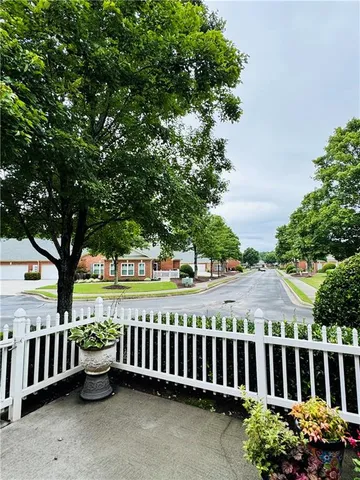 a view of a garden with iron fence