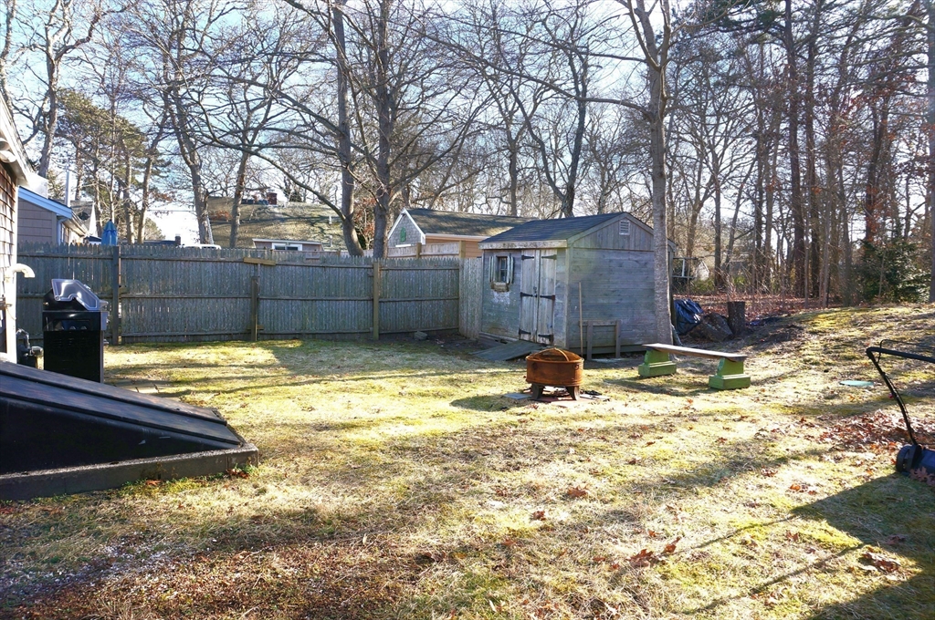 9 Circuit Road West Yarmouth, MA 02673 - Photo 20 of 23 a view of a backyard with a large tree