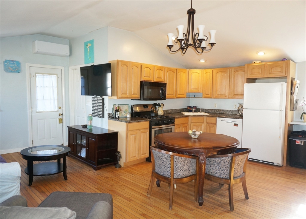 9 Circuit Road West Yarmouth, MA 02673 - Photo 7 of 23 a kitchen with a dining table and chairs