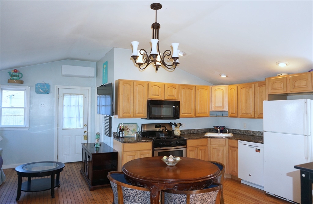 9 Circuit Road West Yarmouth, MA 02673 - Photo 10 of 23 a kitchen with a dining table and chairs