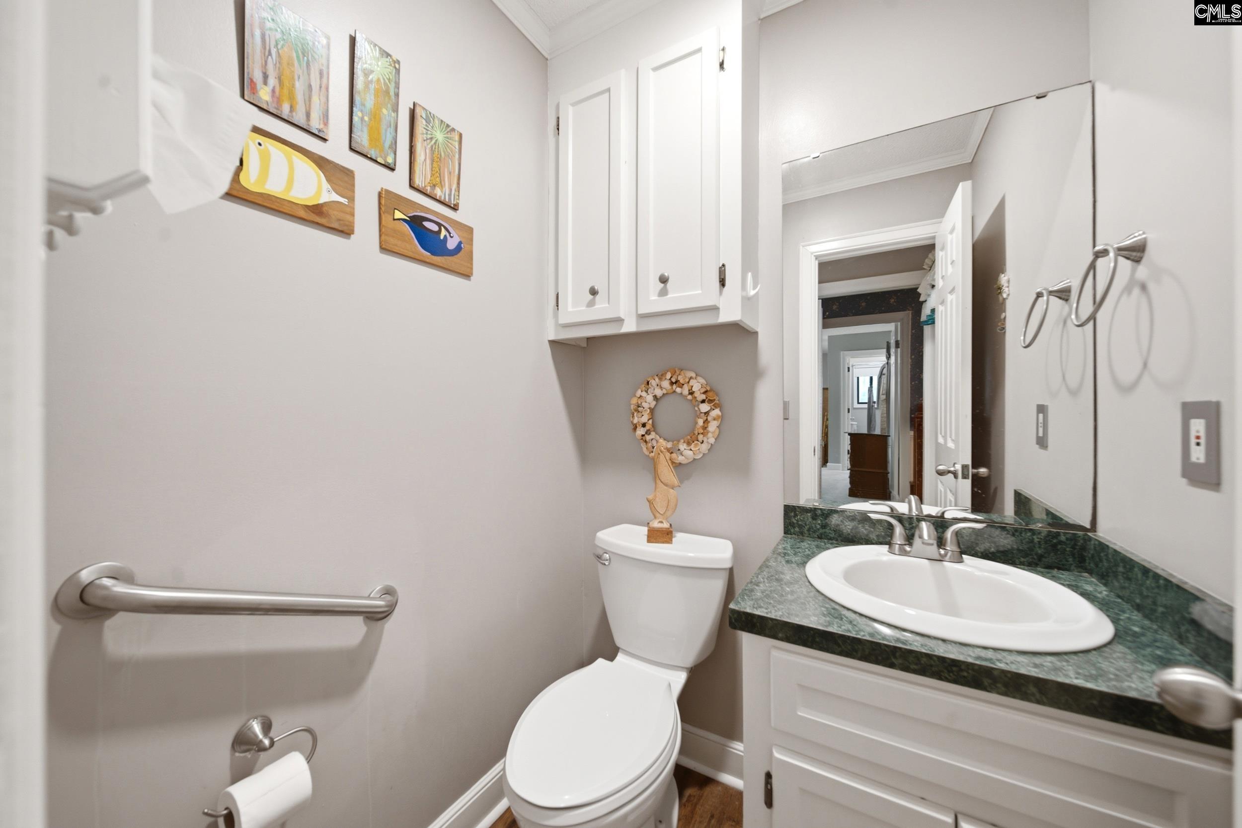 4324 Syrup Mill Road Ridgeway, SC 29130 - Photo 22 of 61 a bathroom with a granite countertop sink a toilet and a mirror