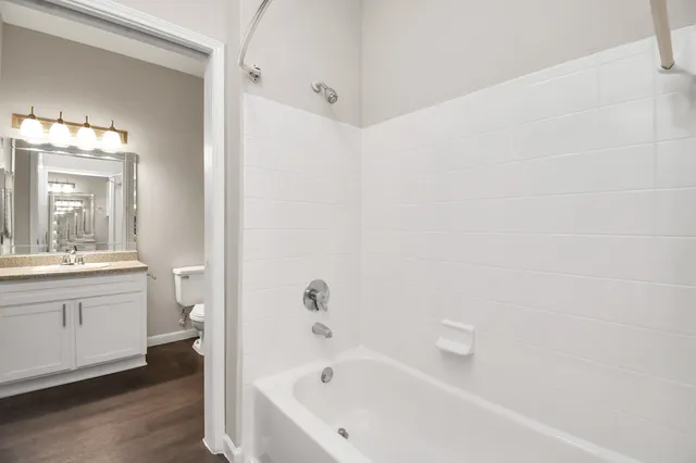 a bathroom with a bathtub and a sink