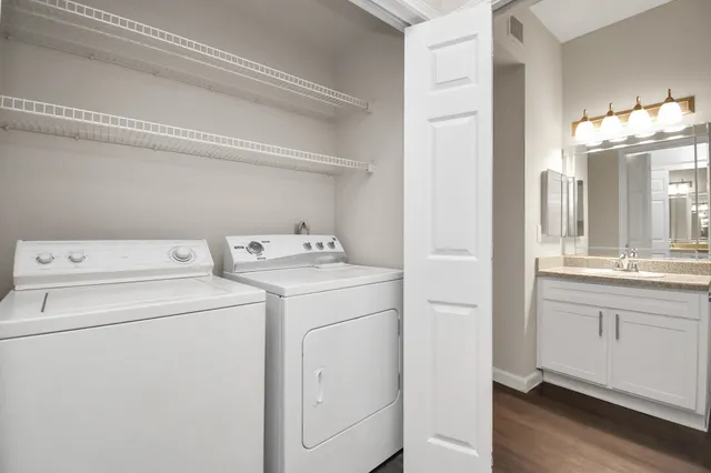 a view of washer and dryer with kitchen view