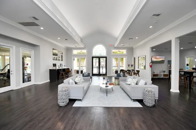 a living room with furniture or wooden floor and a large window
