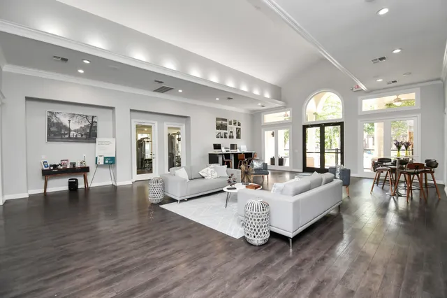 a living room with furniture and a wooden floor