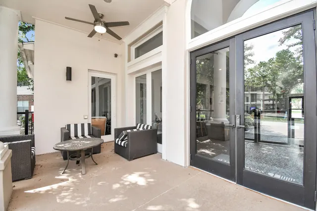 a living room with a couch a fireplace and a floor to ceiling window
