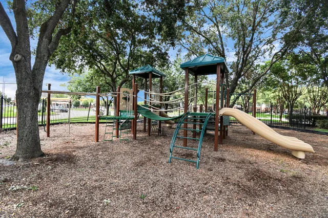 a backyard of a house with barbeque oven table and chairs