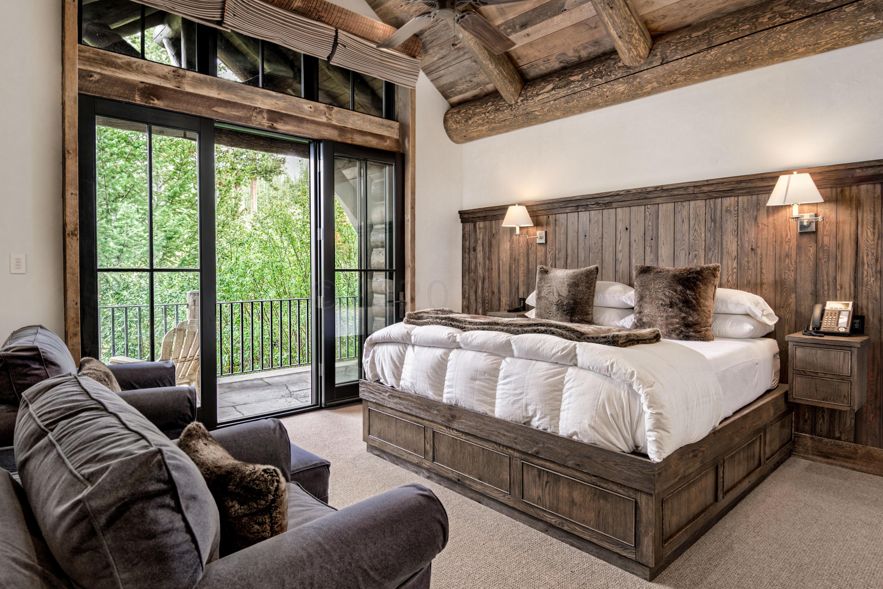 1580 Cresta Road Edwards, CO 81632 - Photo 17 of 25 a bedroom with a bed couch and a large window