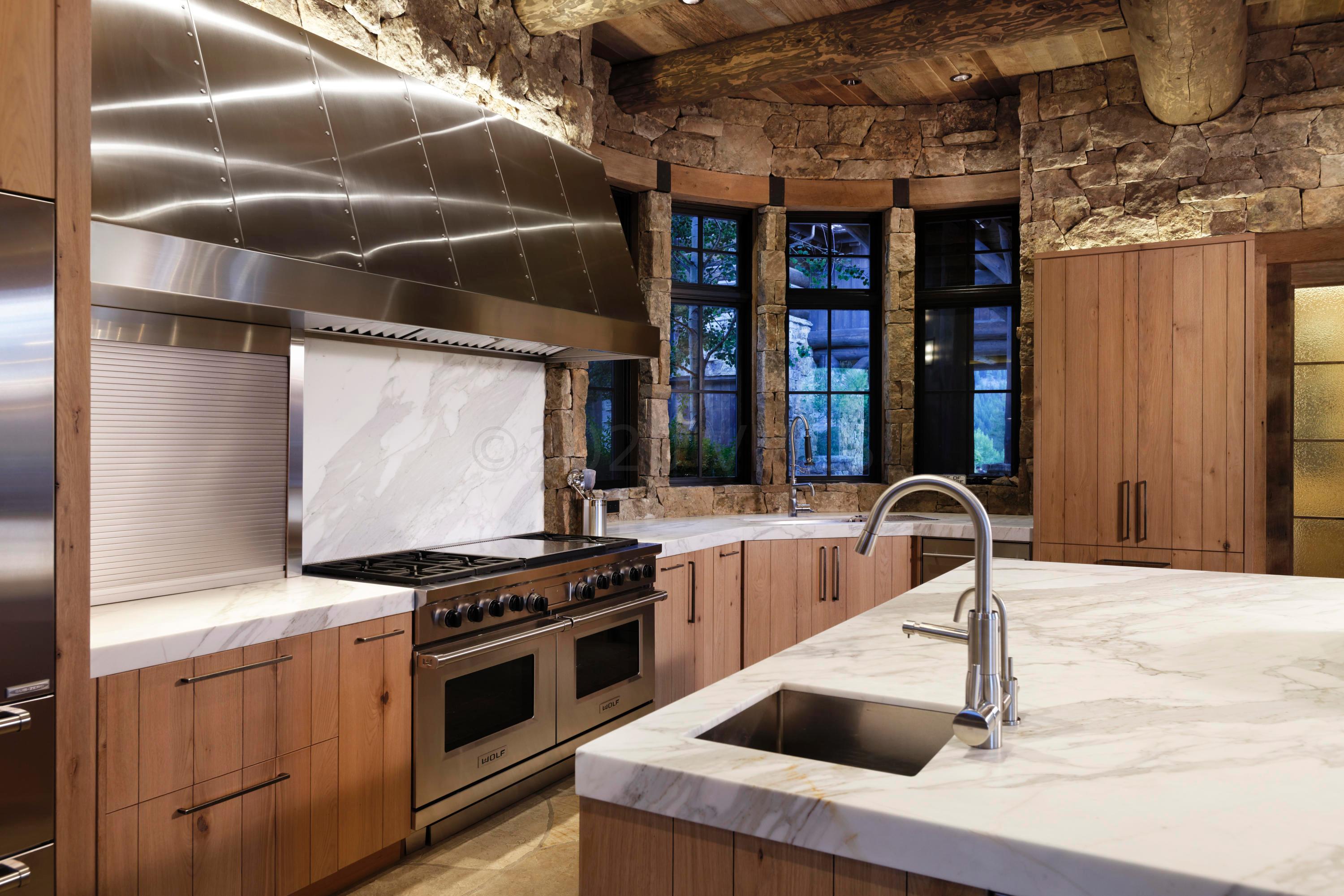 1580 Cresta Road Edwards, CO 81632 - Photo 10 of 25 a kitchen with stainless steel appliances kitchen island granite countertop a stove a sink and a microwave