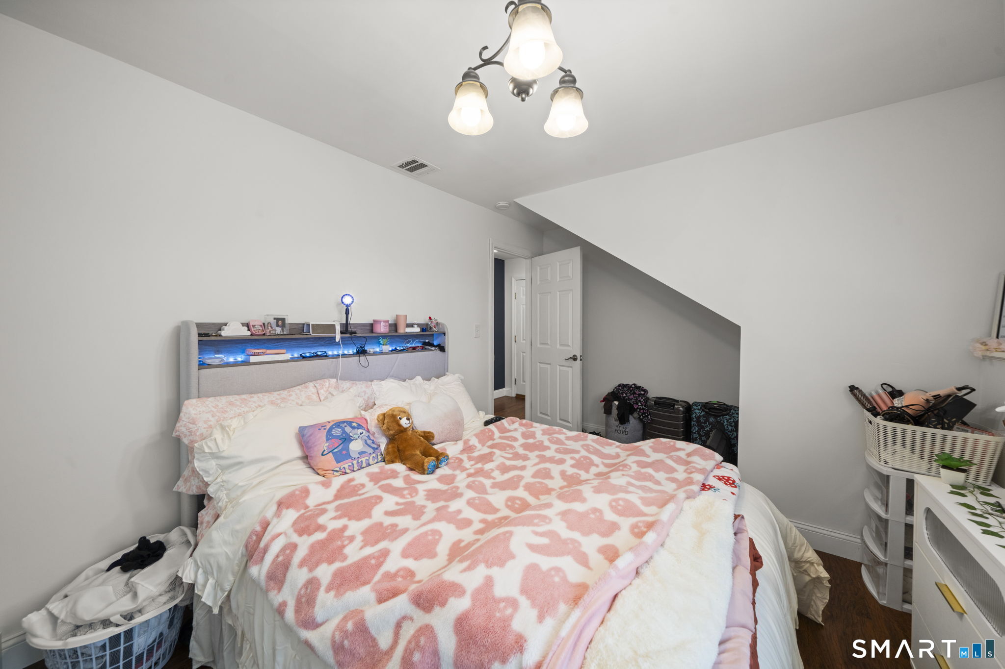 1118 Spindle Hill Road Wolcott, CT 06716 - Photo 27 of 38 a bedroom with a bed and a chandelier