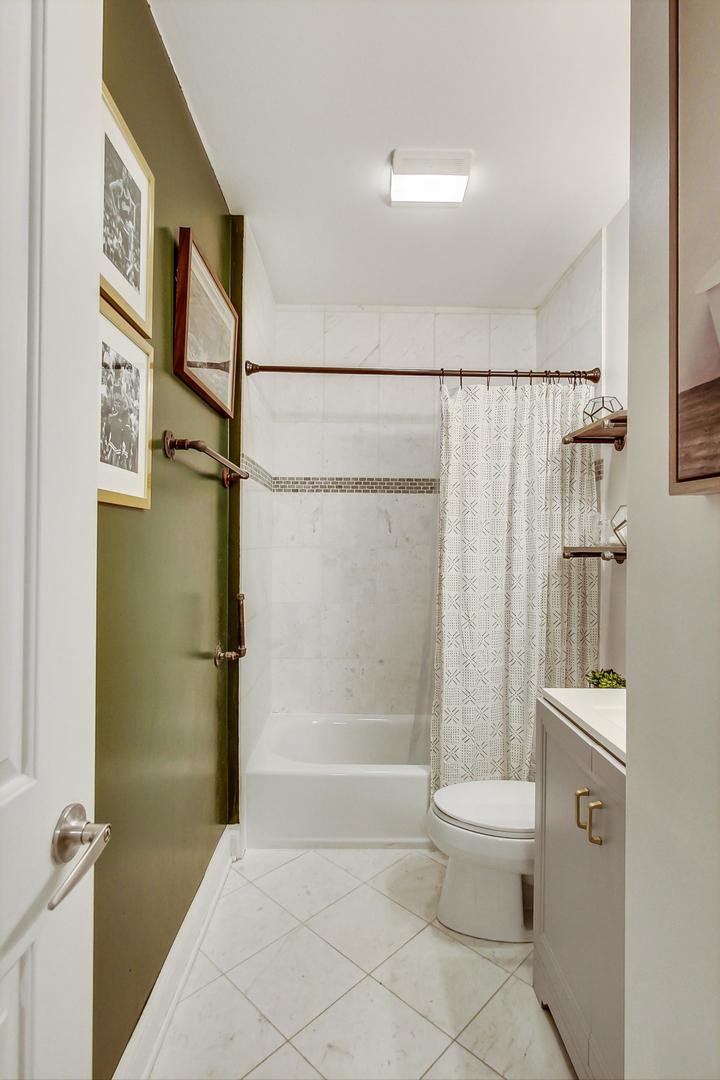2142 West Addison Street, Unit 1A Chicago, IL 60618 - Photo 14 of 23 a bathroom with a shower a toilet and sink