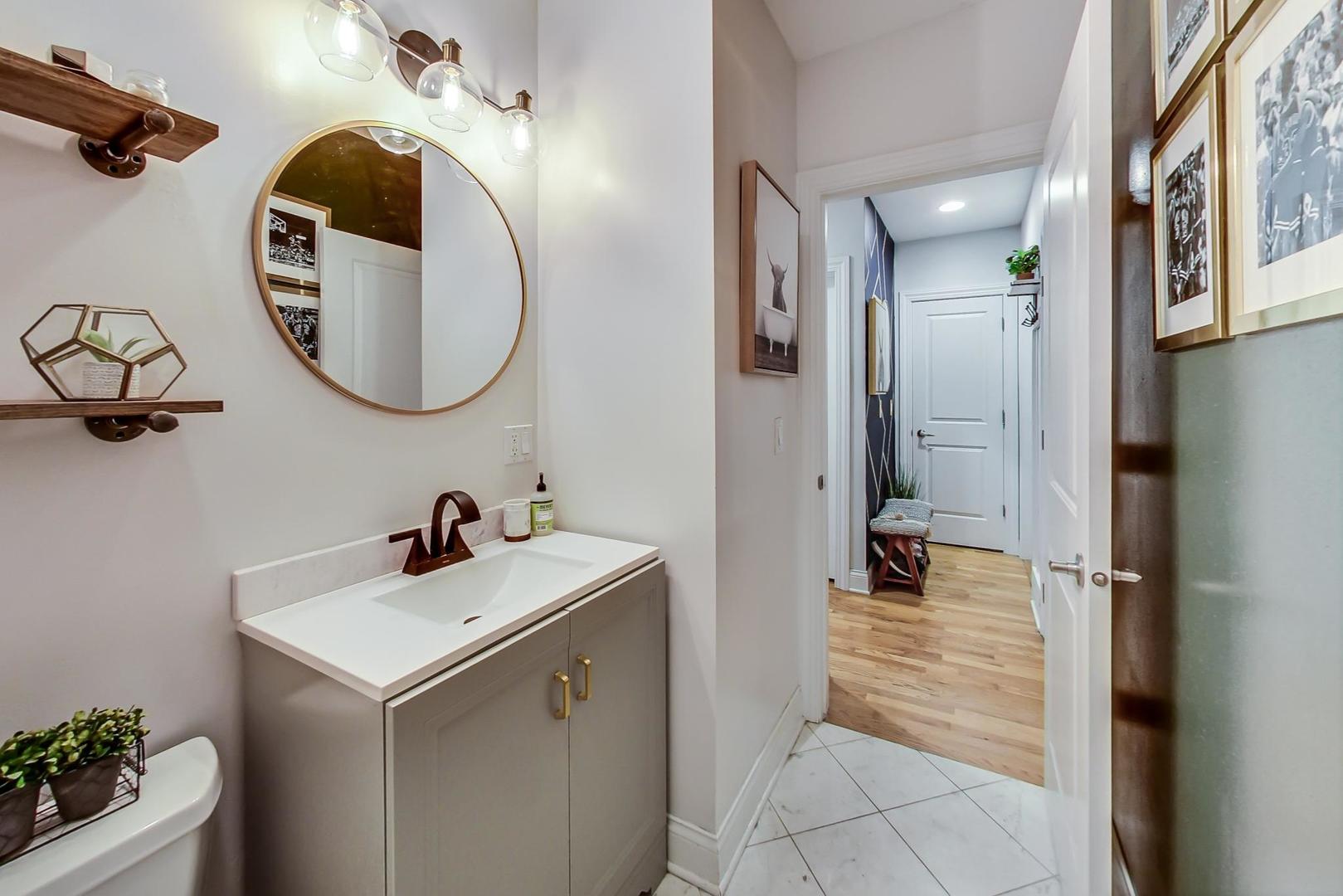 2142 West Addison Street, Unit 1A Chicago, IL 60618 - Photo 15 of 23 a bathroom with a sink and a mirror