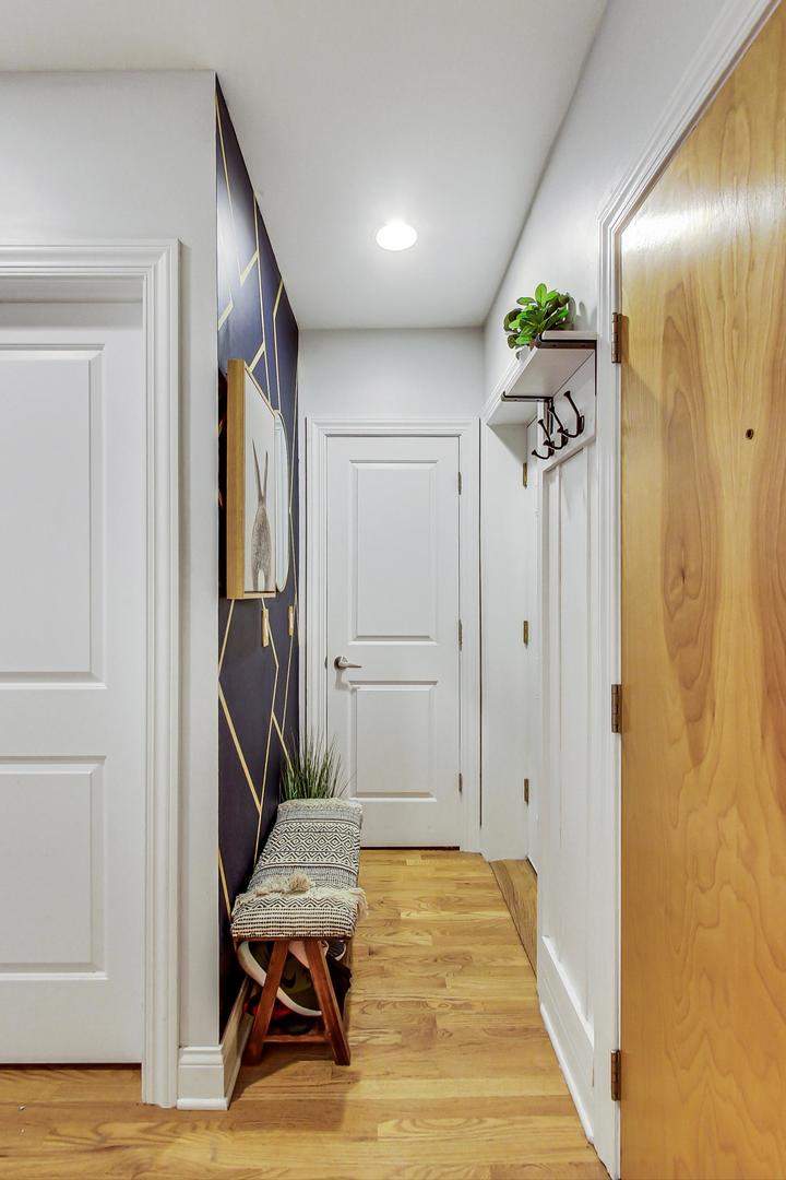 2142 West Addison Street, Unit 1A Chicago, IL 60618 - Photo 16 of 23 a view of a hallway with entryway wooden floor and front door