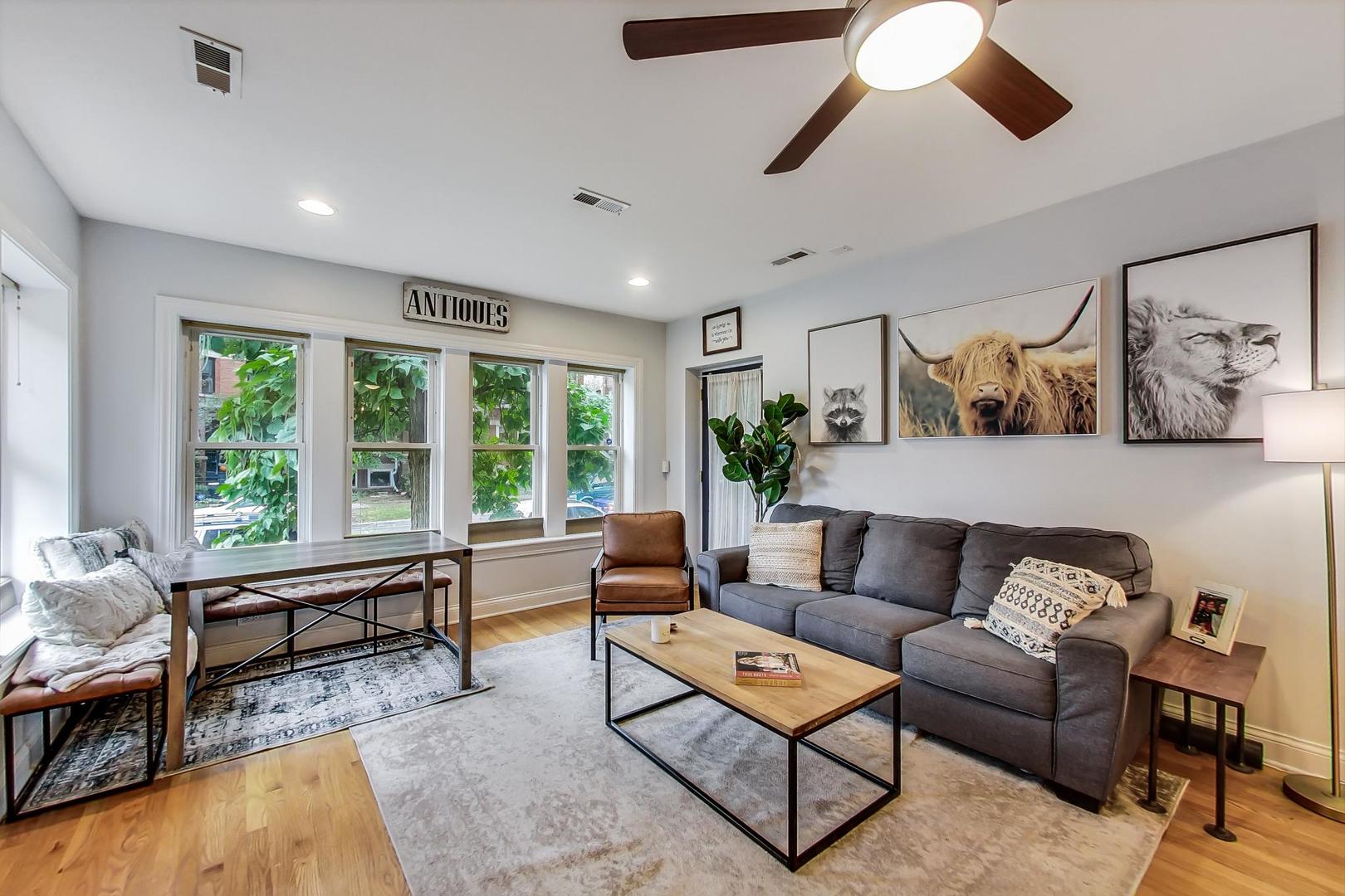 2142 West Addison Street, Unit 1A Chicago, IL 60618 - Photo 3 of 23 a living room with furniture and a large window