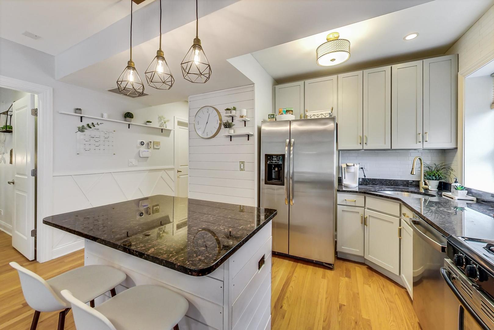 2142 West Addison Street, Unit 1A Chicago, IL 60618 - Photo 7 of 23 a kitchen with stainless steel appliances granite countertop a sink a refrigerator and a stove