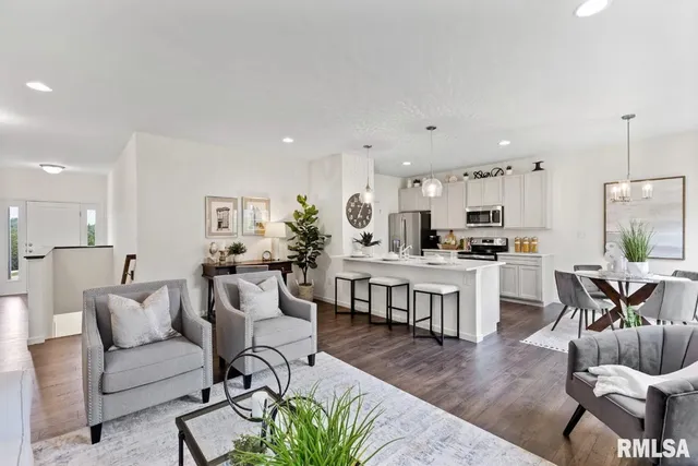 a living room with furniture and kitchen view