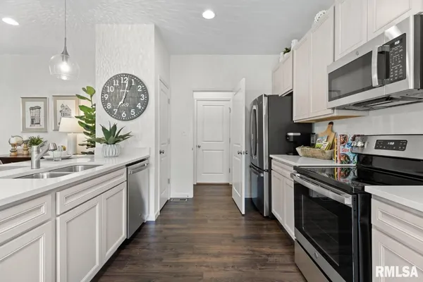 a kitchen with a sink stainless steel appliances and cabinets