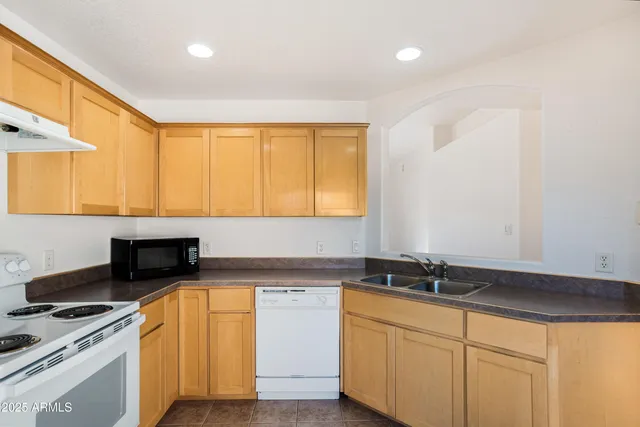 a kitchen with sink and cabinets