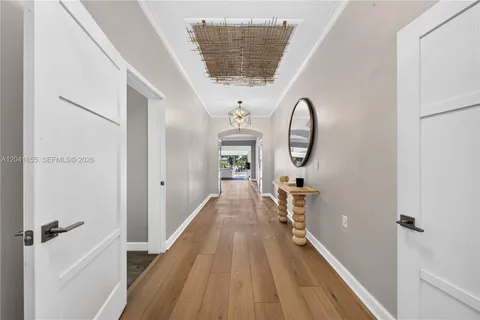 a large bed sitting in a bedroom next to a window