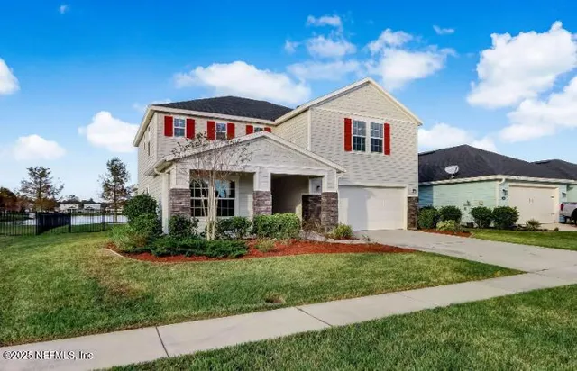a front view of a house with a garden and plants