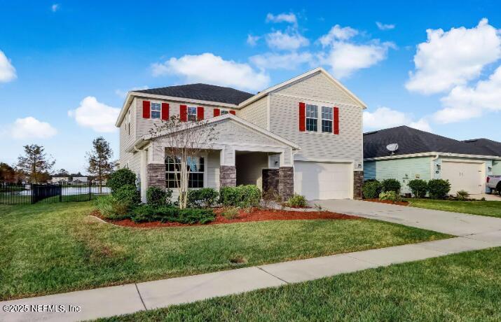 102 Bluejack Lane St. Augustine, FL 32095 - Photo 1 of 32 a front view of a house with a garden and plants