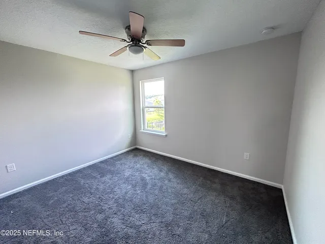 a view of an empty room and a window