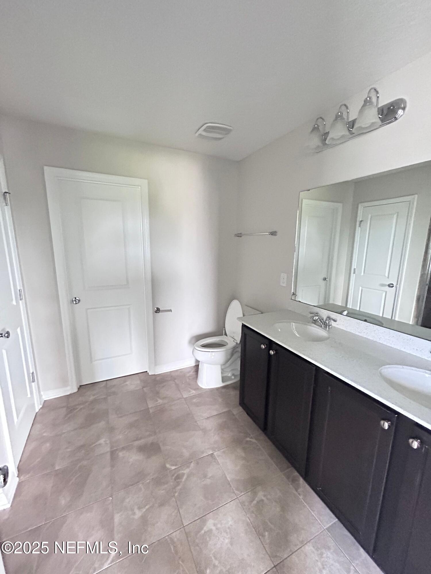 102 Bluejack Lane St. Augustine, FL 32095 - Photo 16 of 32 a bathroom with a double vanity sink mirror and toilet