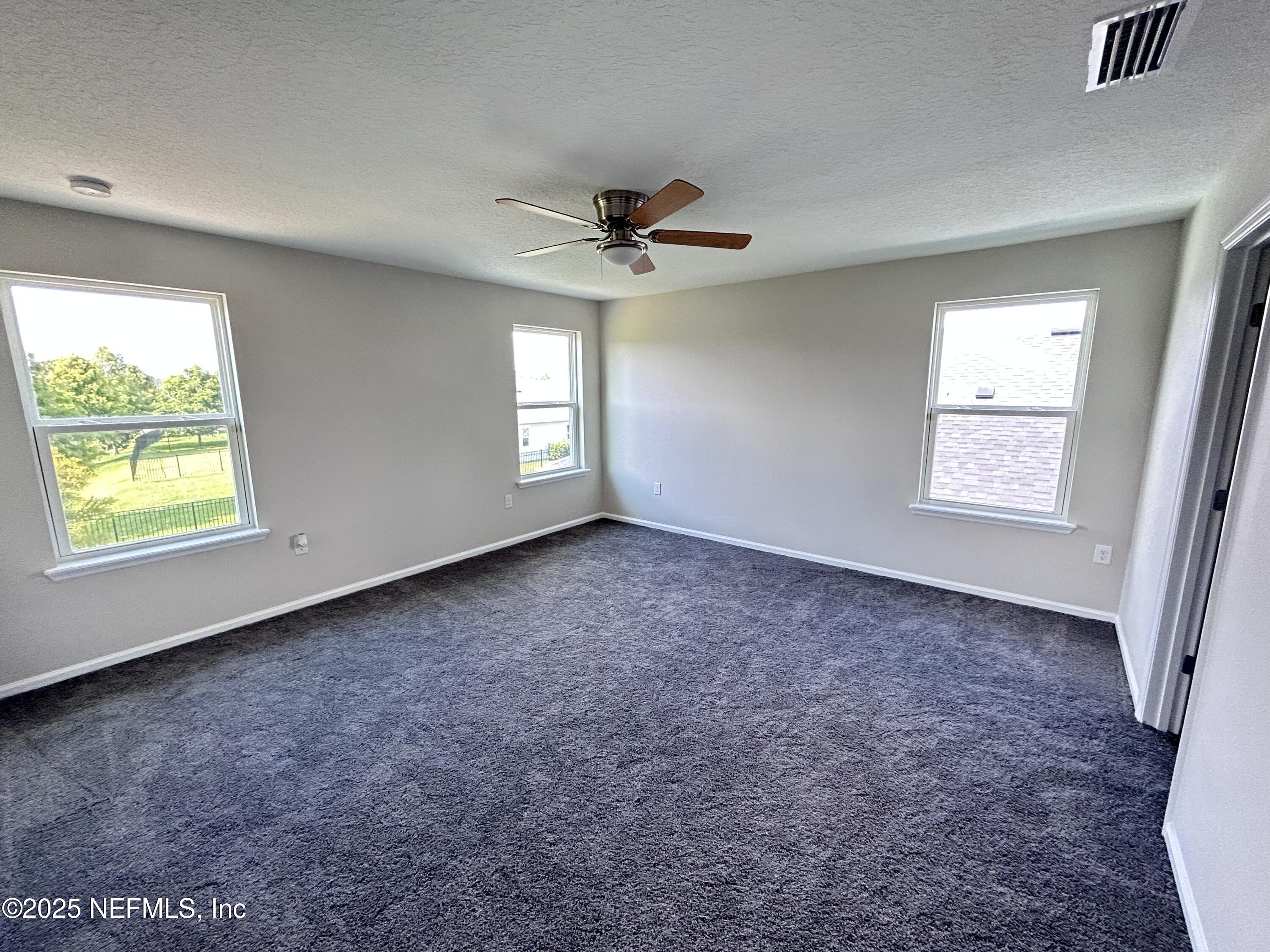 102 Bluejack Lane St. Augustine, FL 32095 - Photo 19 of 32 an empty room with windows and ceiling fan