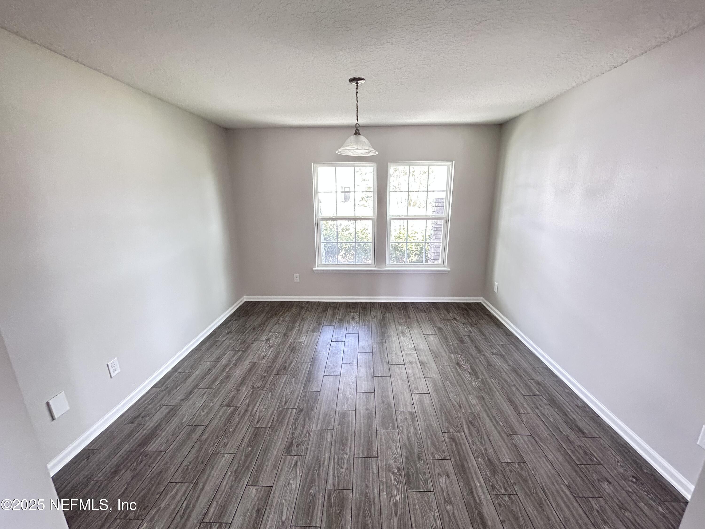 102 Bluejack Lane St. Augustine, FL 32095 - Photo 24 of 32 an empty room with wooden floor and windows
