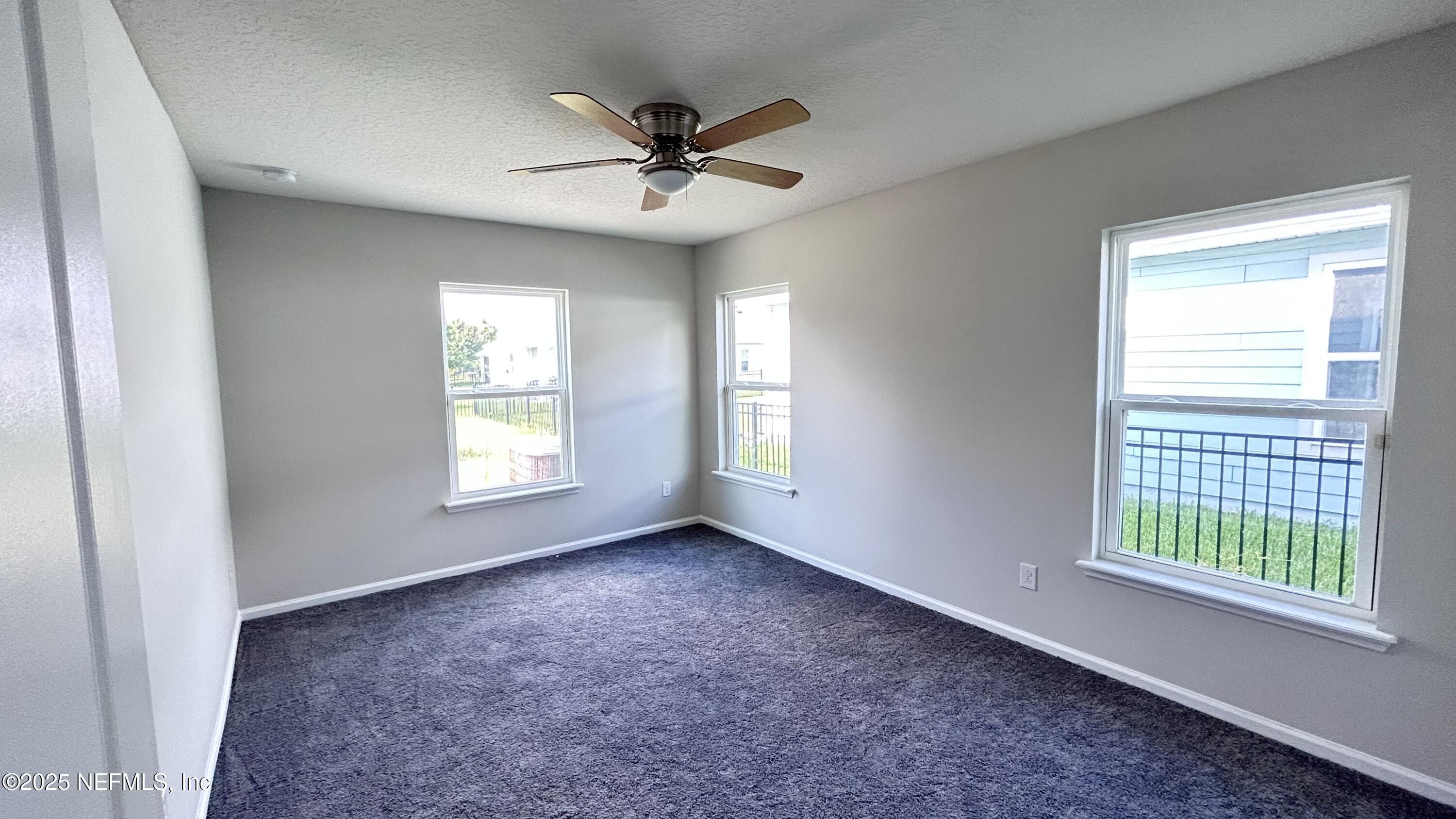 102 Bluejack Lane St. Augustine, FL 32095 - Photo 25 of 32 a view of a livingroom with a ceiling fan and window
