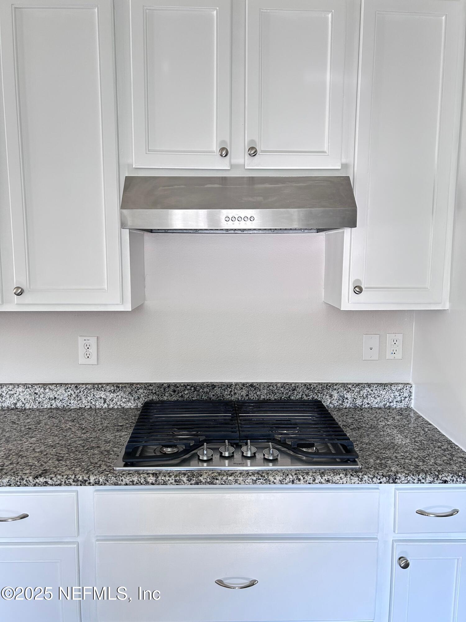 102 Bluejack Lane St. Augustine, FL 32095 - Photo 27 of 32 a close view of a stove a microwave and cabinets