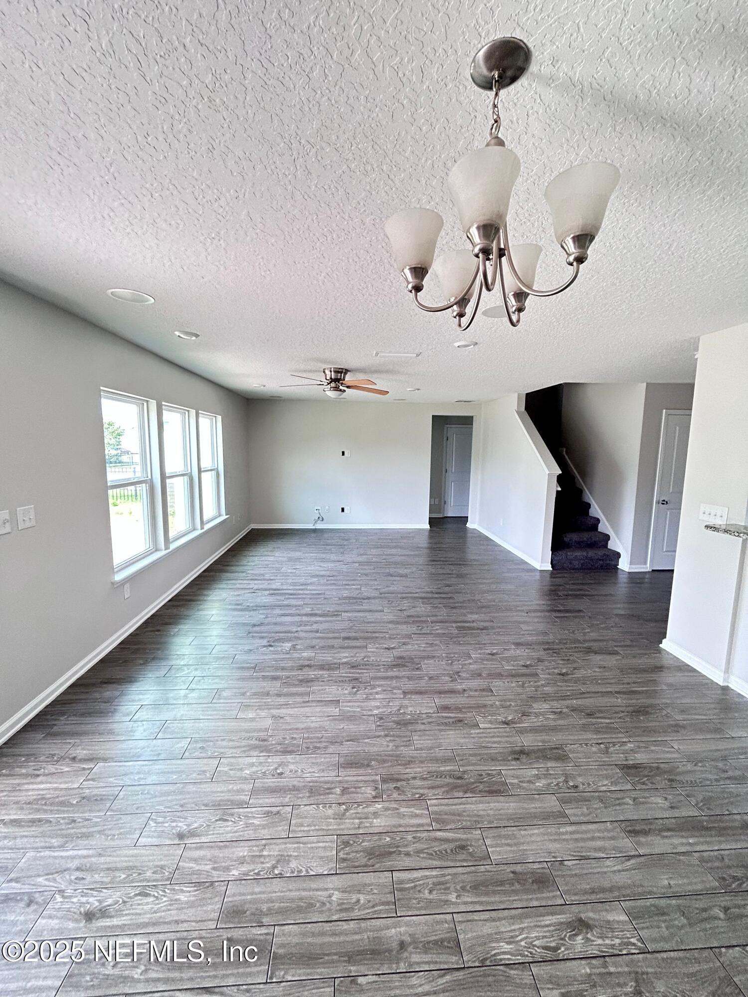 102 Bluejack Lane St. Augustine, FL 32095 - Photo 30 of 32 a view of an empty room with window and wooden floor