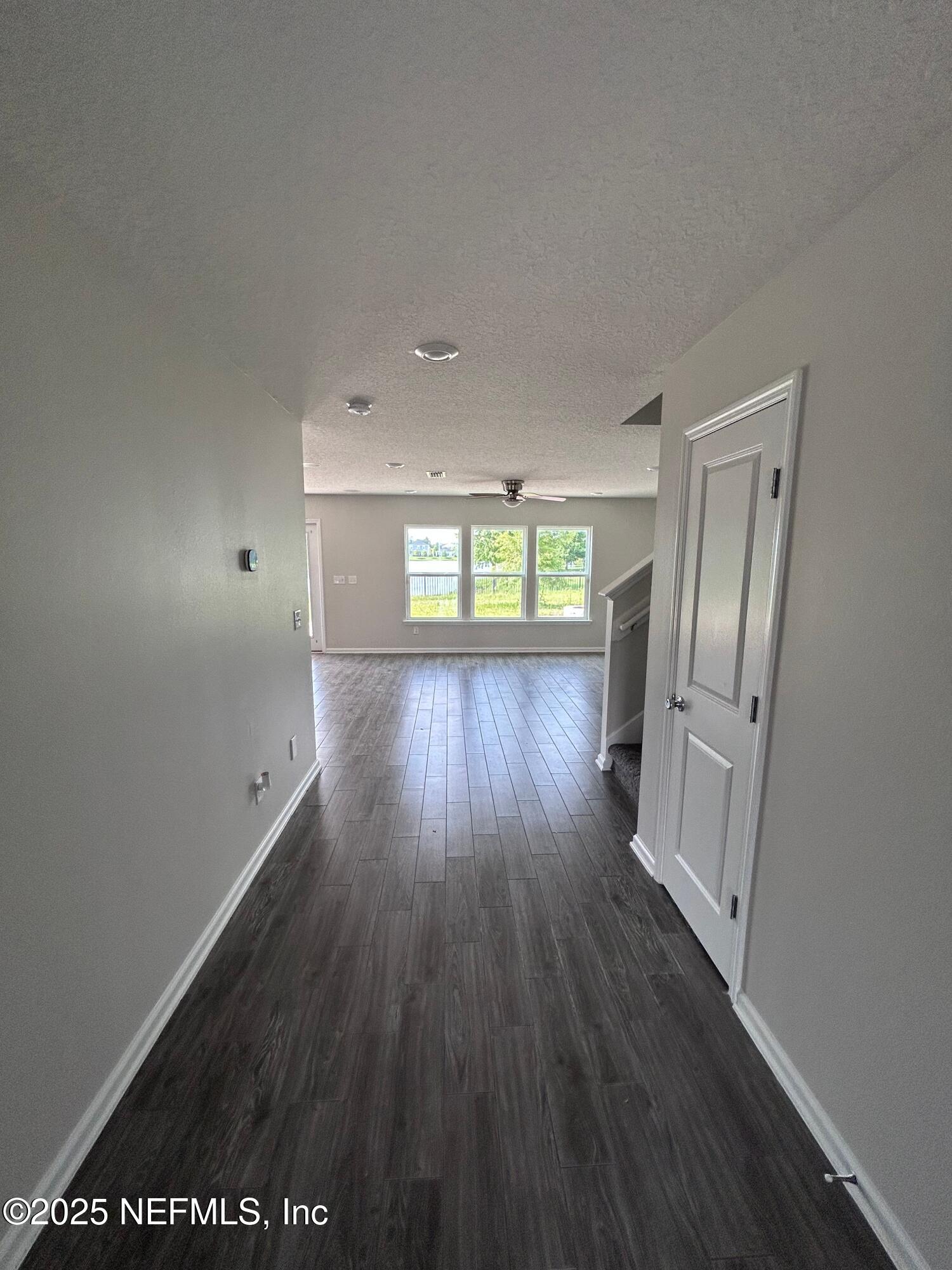 102 Bluejack Lane St. Augustine, FL 32095 - Photo 32 of 32 wooden floor in an empty room with a window