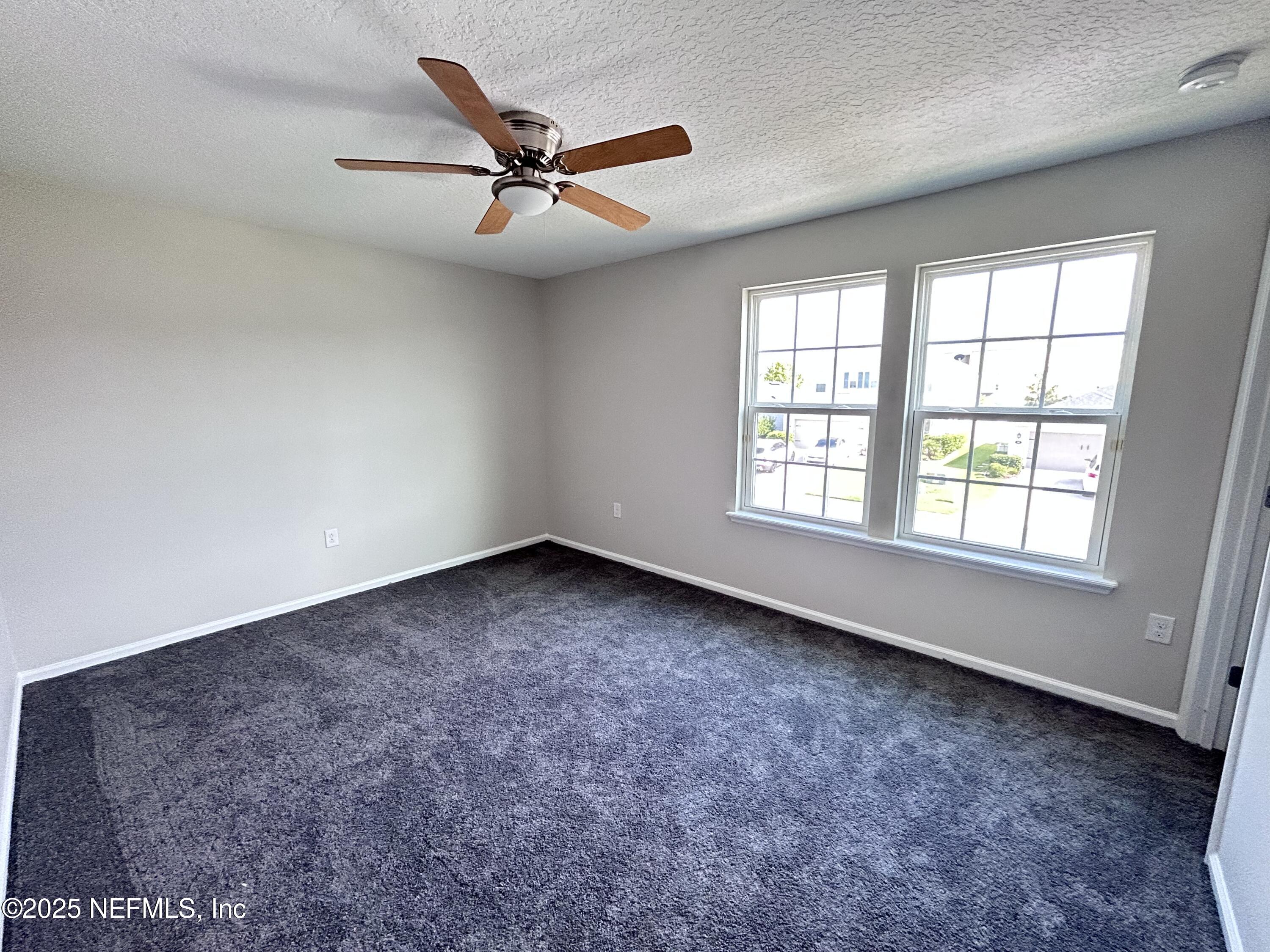 102 Bluejack Lane St. Augustine, FL 32095 - Photo 9 of 32 an empty room with windows and fan