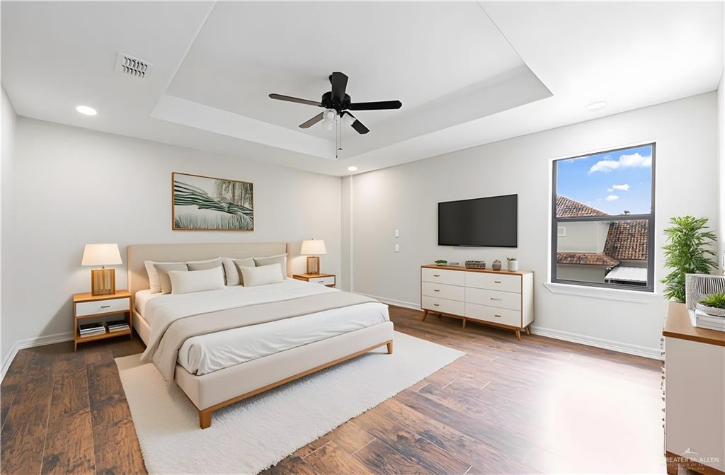 2216 South 45th Street McAllen, TX 78503 - Photo 11 of 34 a bedroom with a bed a flat screen tv and a couch