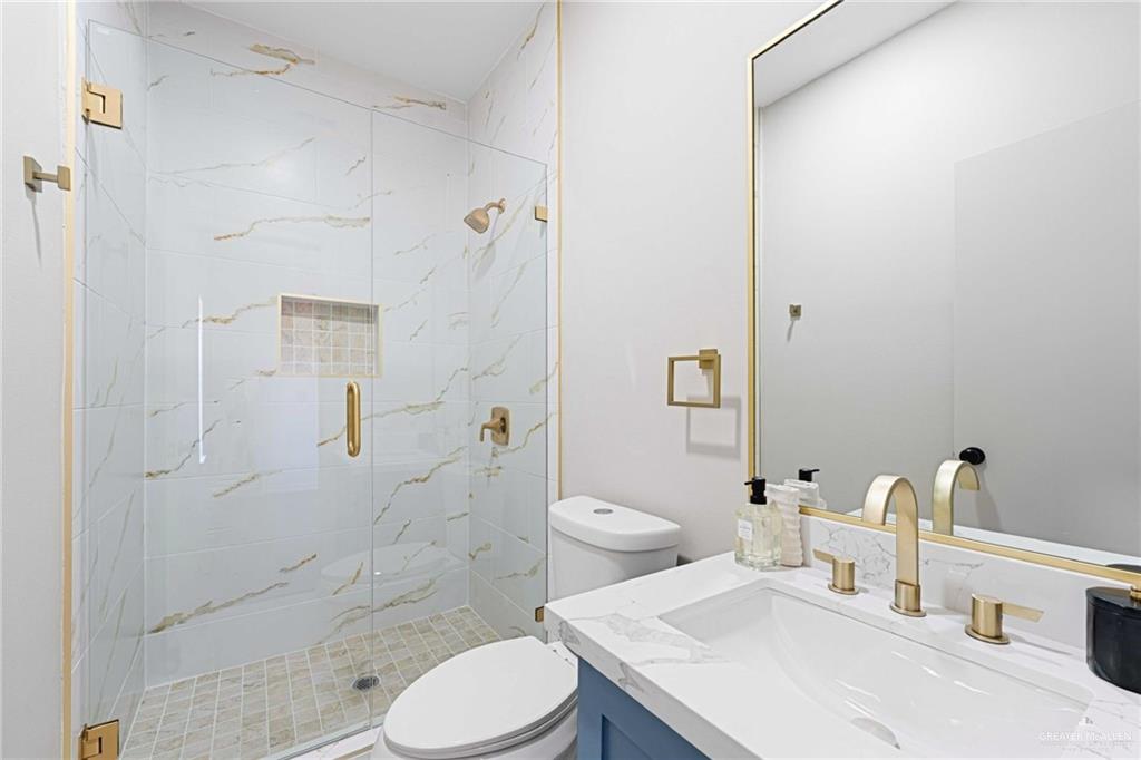 2216 South 45th Street McAllen, TX 78503 - Photo 15 of 34 a bathroom with a sink toilet and shower