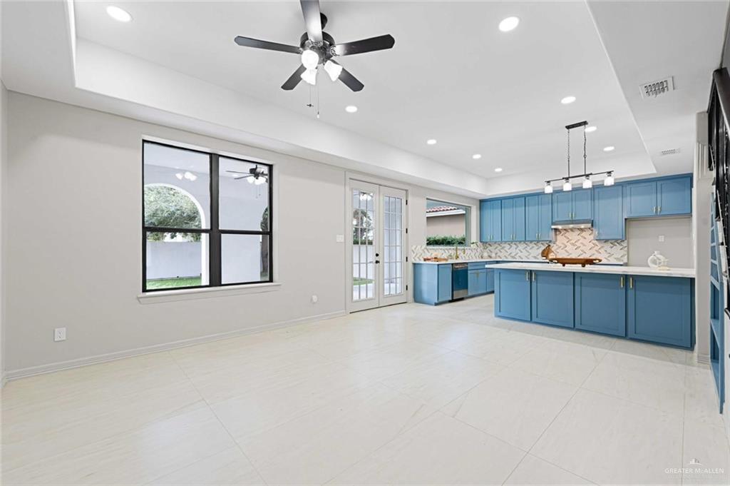 2216 South 45th Street McAllen, TX 78503 - Photo 29 of 34 a large kitchen with stainless steel appliances kitchen island a large counter top a sink and a refrigerator