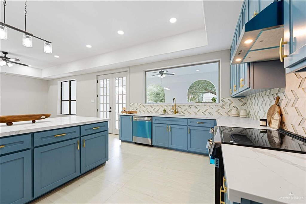 2216 South 45th Street McAllen, TX 78503 - Photo 8 of 34 a large kitchen with kitchen island a sink stainless steel appliances and cabinets