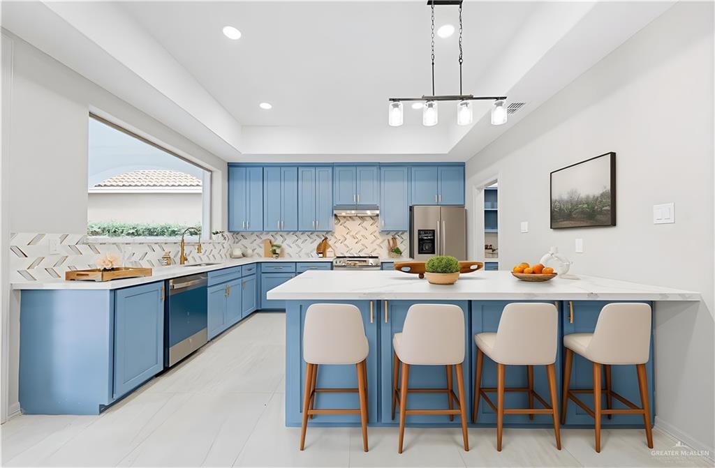 2216 South 45th Street McAllen, TX 78503 - Photo 9 of 34 a kitchen with a dining table chairs and white cabinets