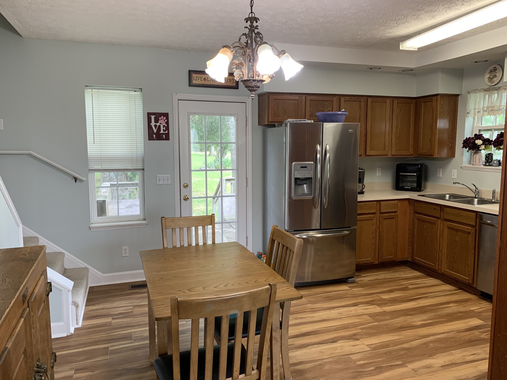 773 Curd Road Mount Juliet, TN 37122 - Photo 4 of 25 a kitchen with stainless steel appliances granite countertop a refrigerator a stove a sink dishwasher and wooden cabinets with wooden floor