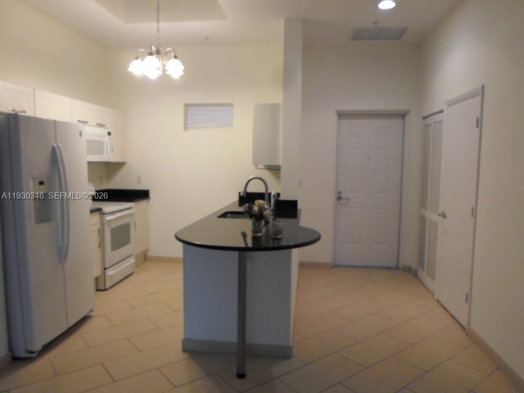 7275 Southwest 90th Way, Unit G 611 Miami, FL 33156 - Photo 24 of 56 a kitchen with stainless steel appliances a sink stove and refrigerator