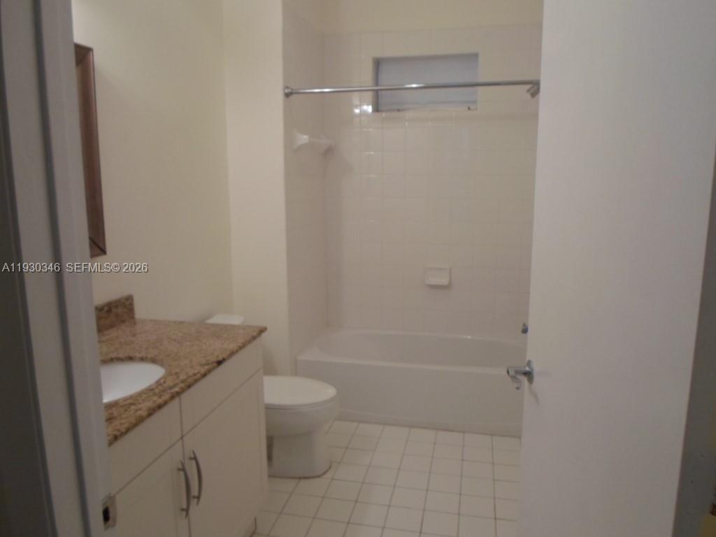 7275 Southwest 90th Way, Unit G 611 Miami, FL 33156 - Photo 28 of 56 a bathroom with a granite countertop sink toilet and shower