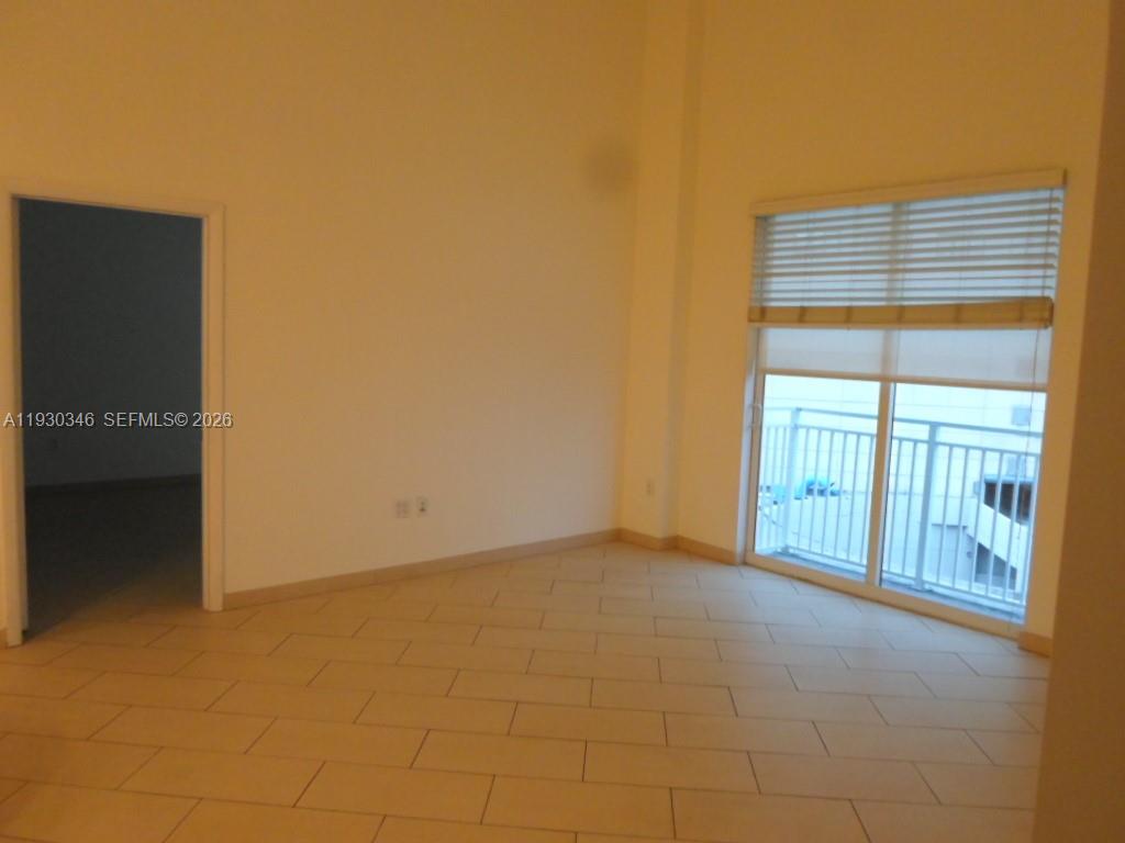 7275 Southwest 90th Way, Unit G 611 Miami, FL 33156 - Photo 31 of 56 a view of an empty room with a window