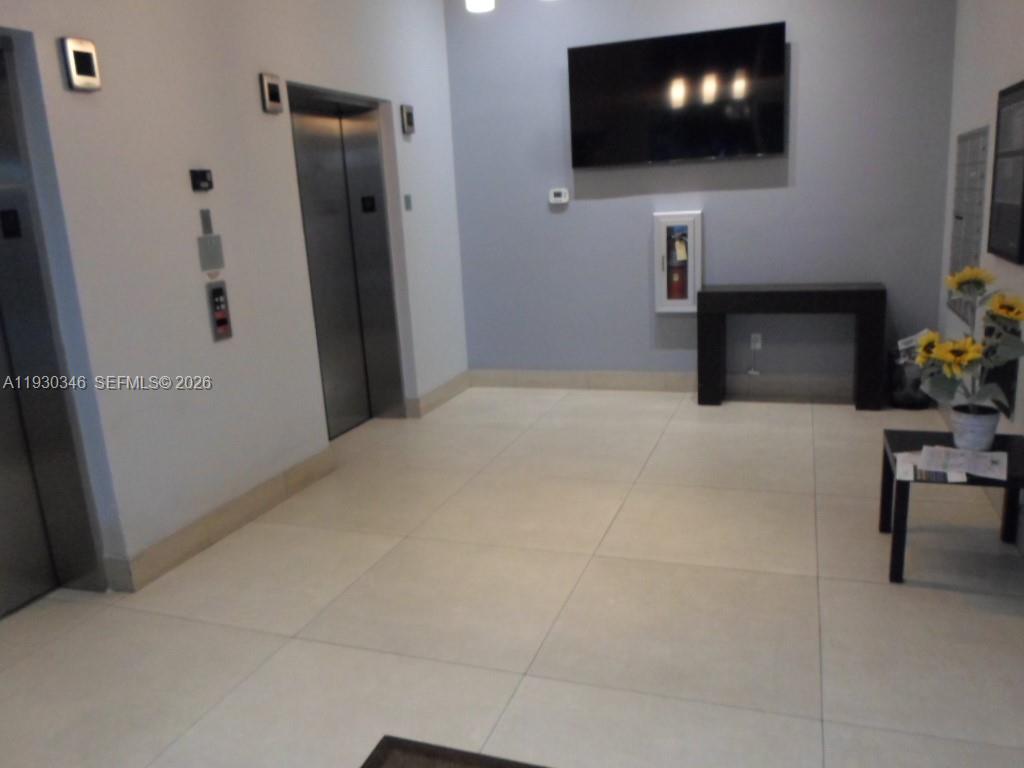 7275 Southwest 90th Way, Unit G 611 Miami, FL 33156 - Photo 56 of 56 a view of a livingroom with furniture and a flat screen tv