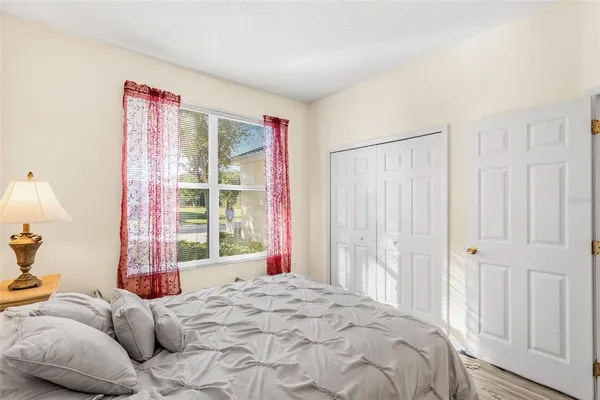 a bedroom with a bed and a window