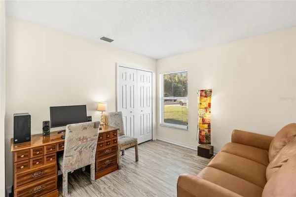 a bedroom with furniture and a wooden floor