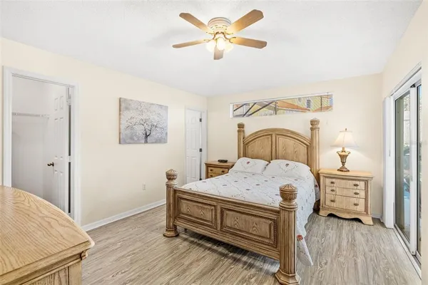 a bedroom with a bed and a chandelier
