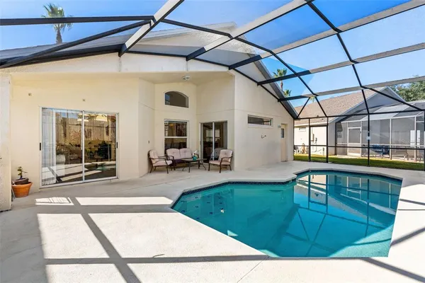 a swimming pool with outdoor seating